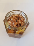 Organic walnuts with honey in hexagon jar